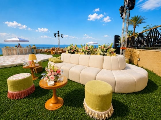 Stylish seating and decor set against a scenic backdrop.