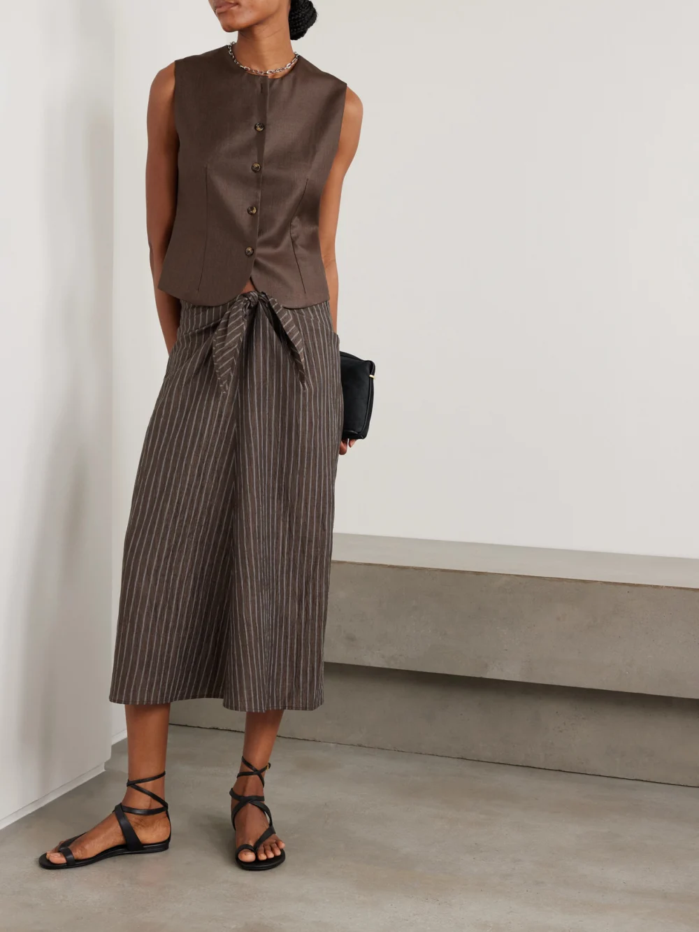 Abadia Tie-detailed Pinstriped Linen-blend Midi Skirt, worn by a model