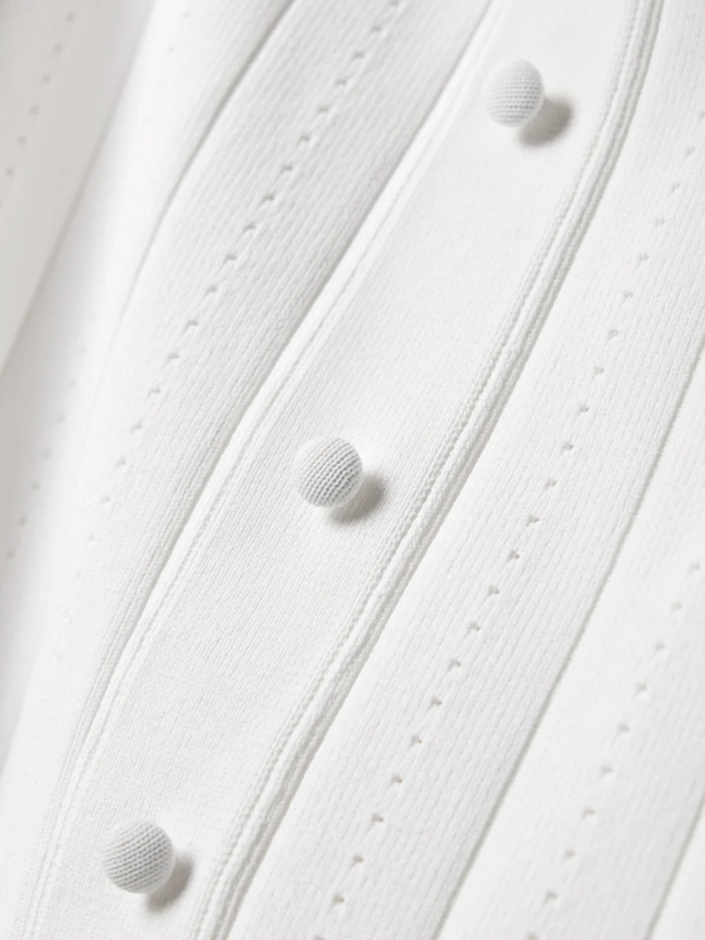 Close-up detail of the Adam Lippes Fenwick Recycled Pointelle-knit Midi Dress