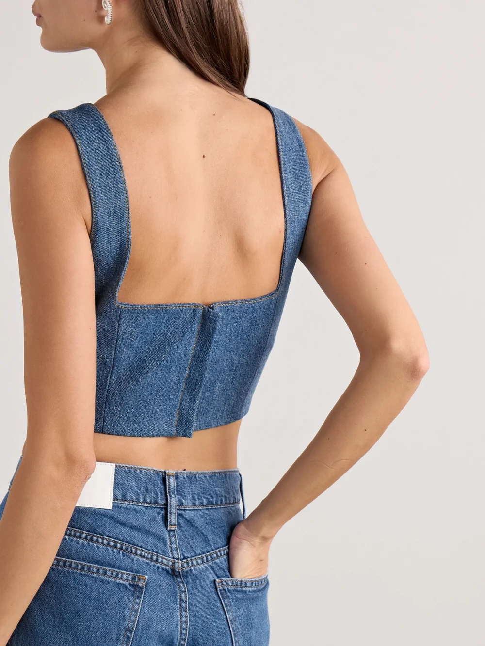 Back view of the Adam Lippes Quinn Button-embellished Cropped Denim Top