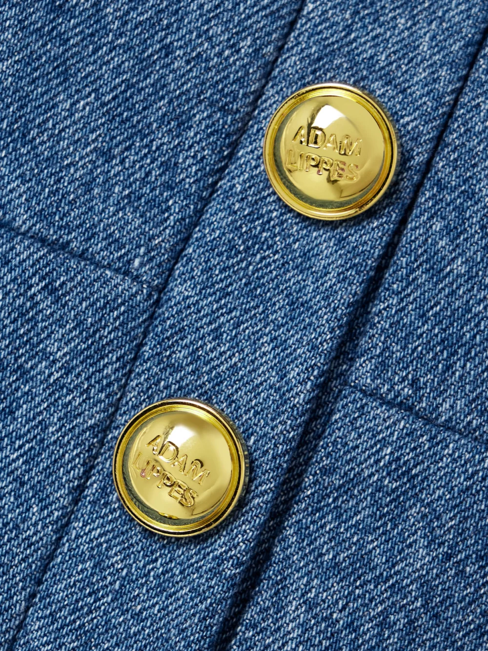 Close-up detail of the Adam Lippes Quinn Button-embellished Cropped Denim Top