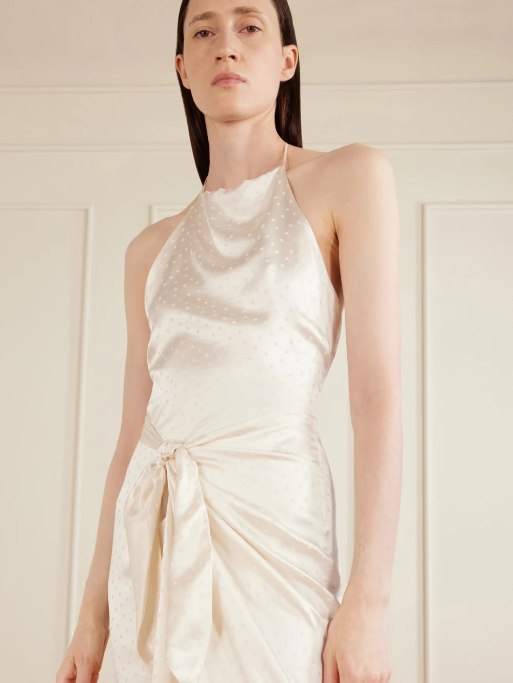 Close-up detail of the Aflalo Nourin Polka-dot Knotted Satin-jacquard Halterneck Maxi Dress