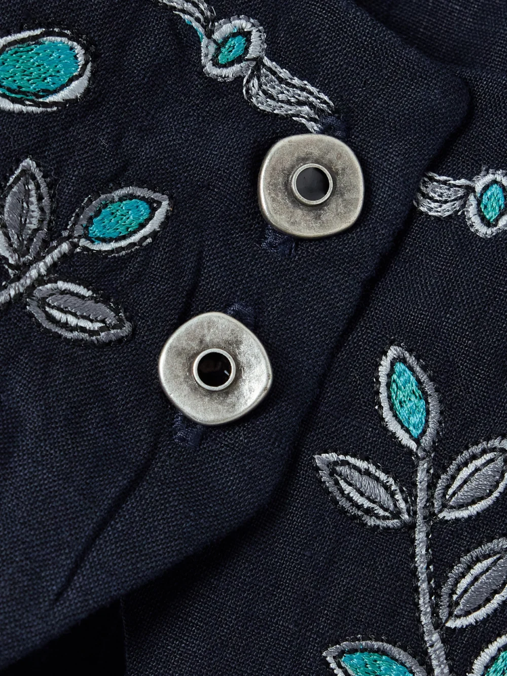 Close-up detail of the Agua by Agua Bendita Esmeralda Relicario Embroidered Linen Cropped Top