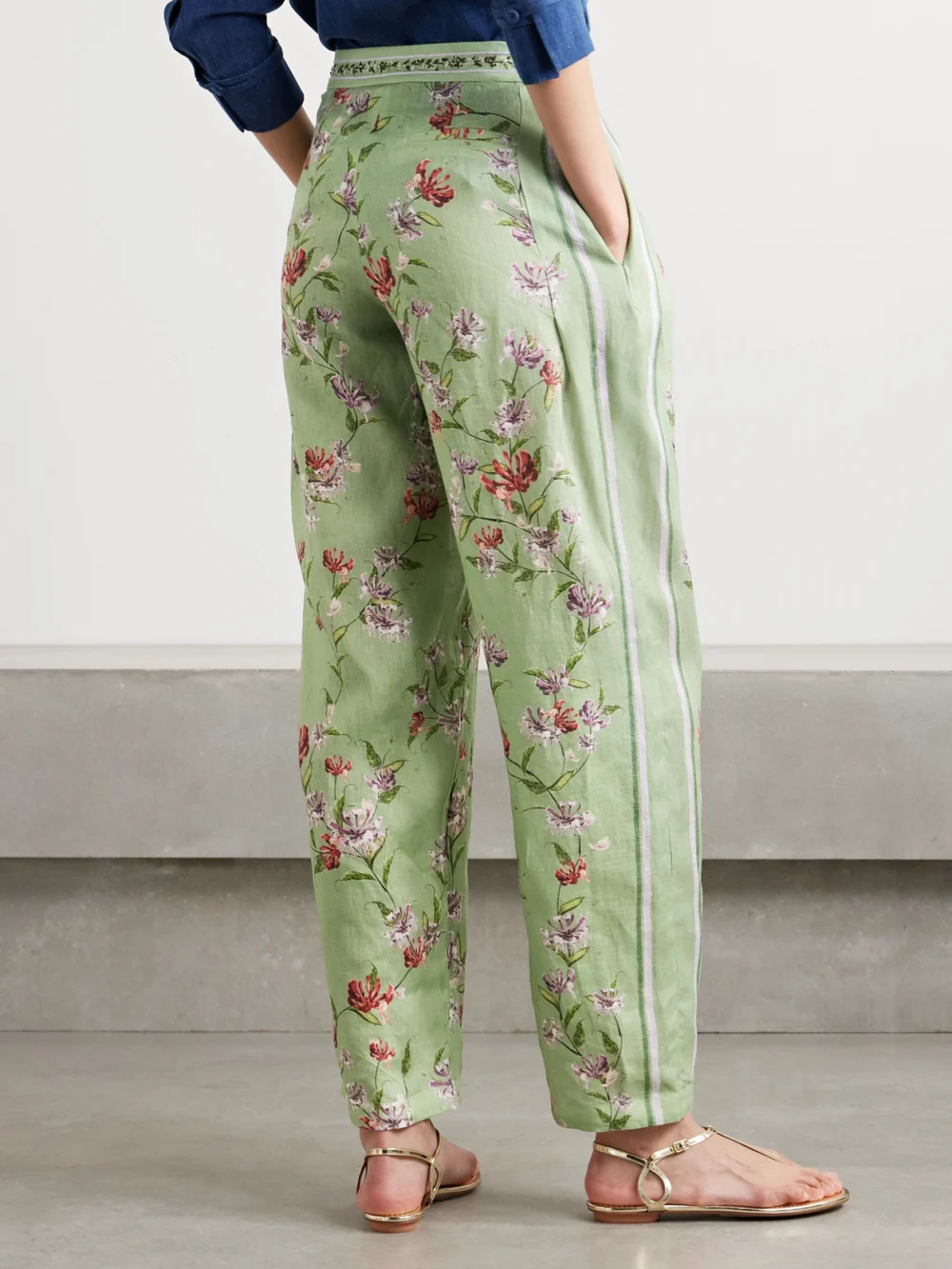 Back view of the Agua by Agua Bendita Florecer Honeysuckle Pleated Embroidered Floral-print Linen Tapered Pants