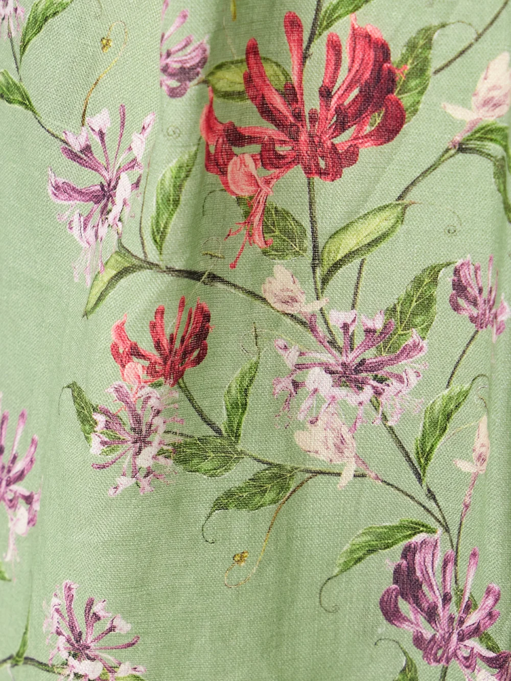 Close-up detail of the Agua by Agua Bendita Florecer Honeysuckle Pleated Embroidered Floral-print Linen Tapered Pants