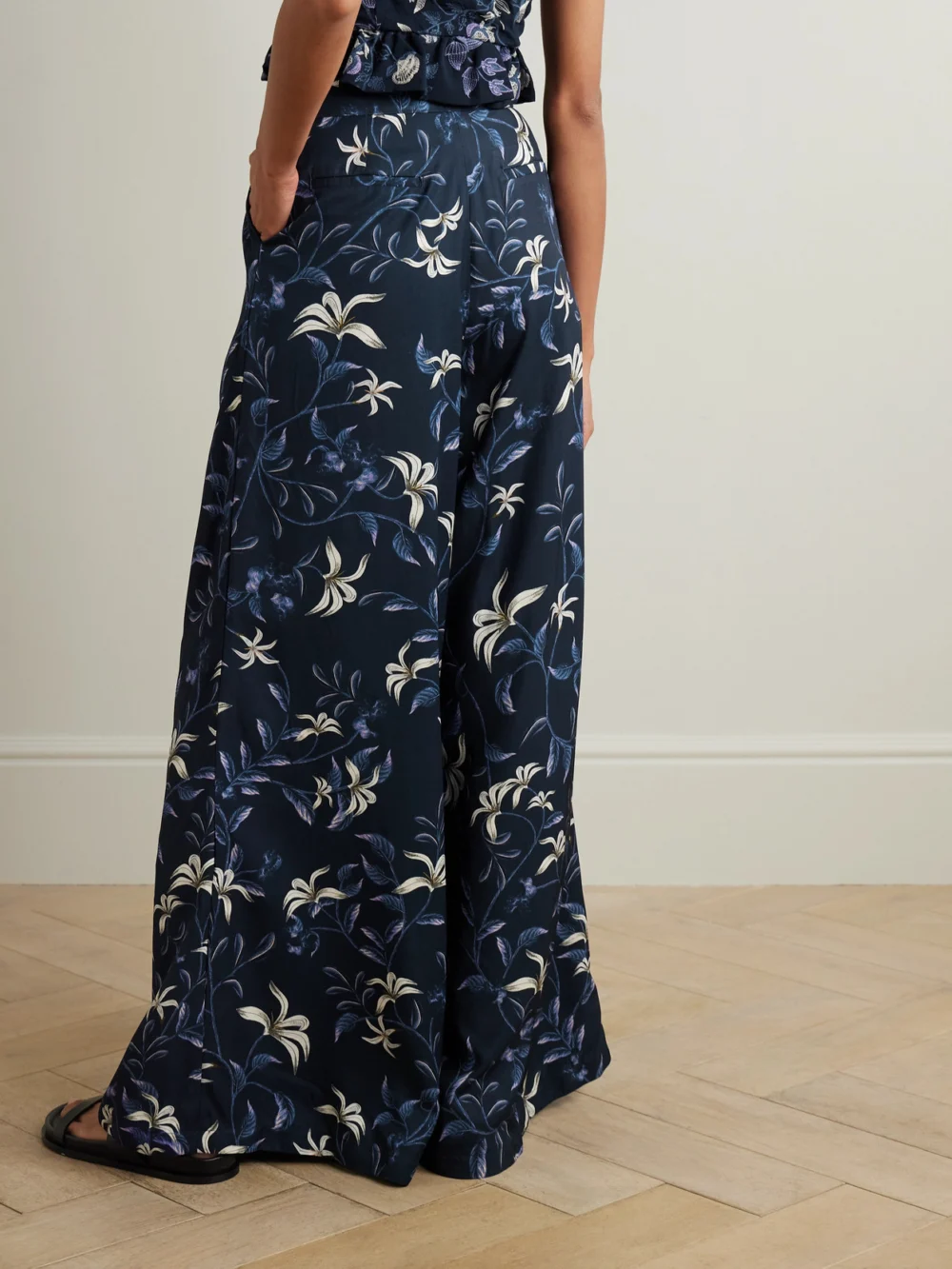 Back view of the Agua by Agua Bendita Piñon Café Floral-print Recycled-twill Wide-leg Pants