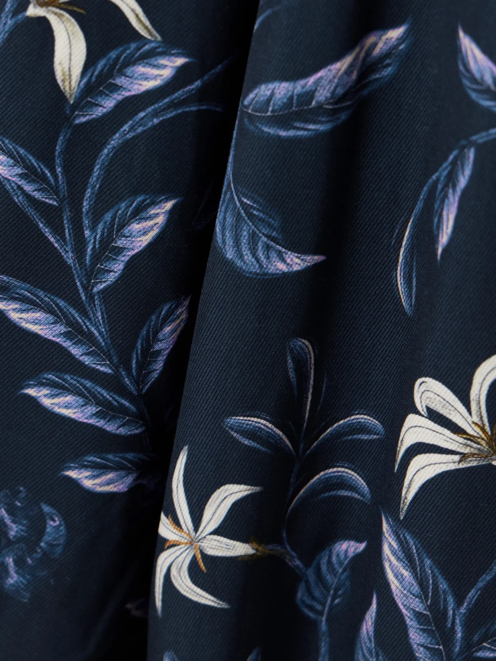 Close-up detail of the Agua by Agua Bendita Piñon Café Floral-print Recycled-twill Wide-leg Pants
