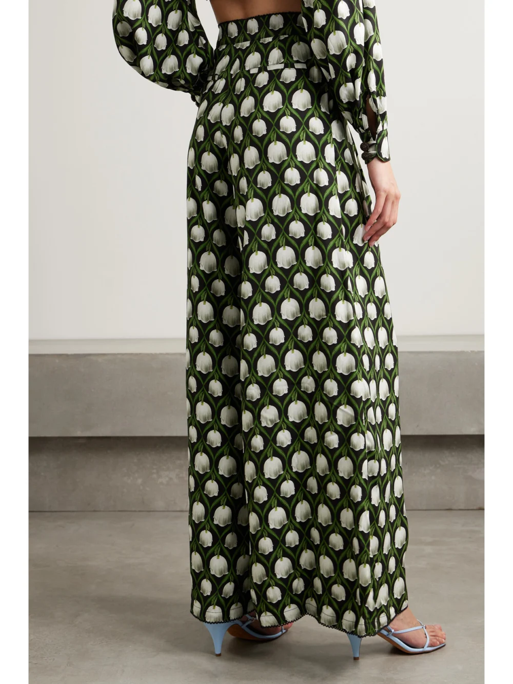 Back view of the Agua by Agua Bendita Piñon Pleated Floral-print Recycled-twill Wide-leg Pants