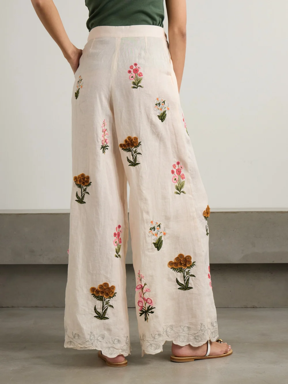 Back view of the Agua by Agua Bendita Piñon Prado Pleated Scalloped Embroidered Linen Wide-leg Pants