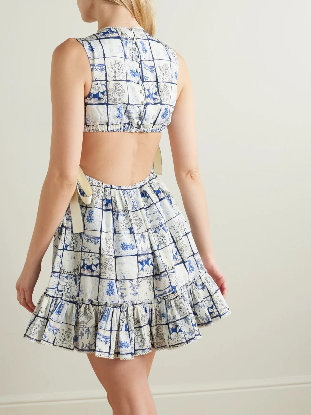 Back view of the Agua by Agua Bendita Sucré Porcelana Cutout Floral-print Cotton-poplin Mini Dress