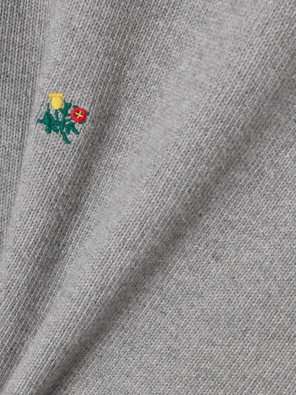 Close-up detail of the Aimé Leon Dore Crest Embroidered Ribbed Cotton Polo Shirt