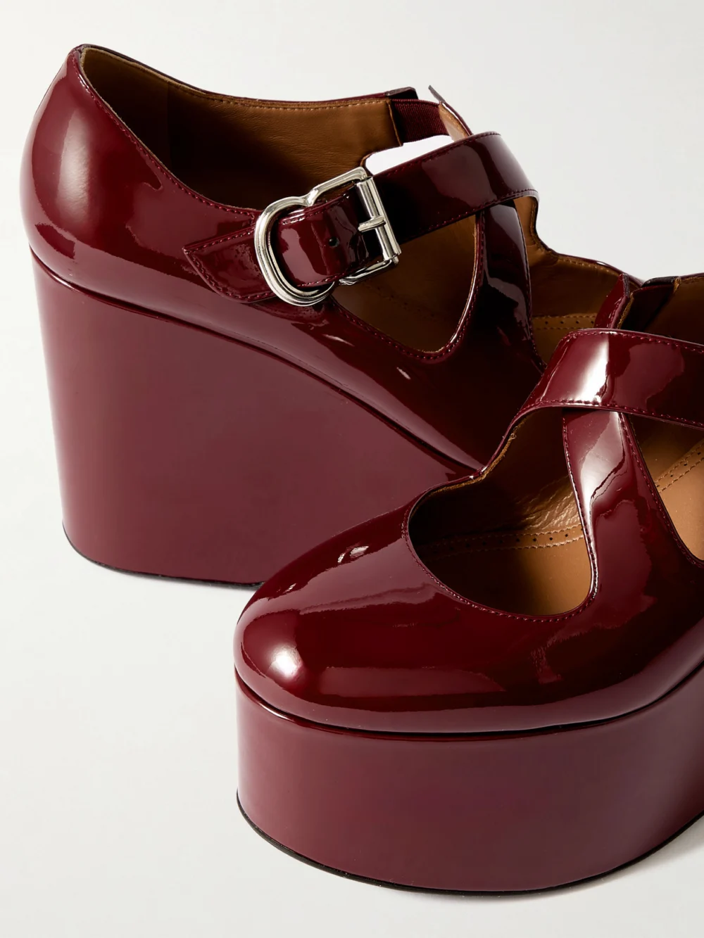 Close-up detail of the Alaïa 110 Patent-leather Platform Wedge Mary Jane Pumps