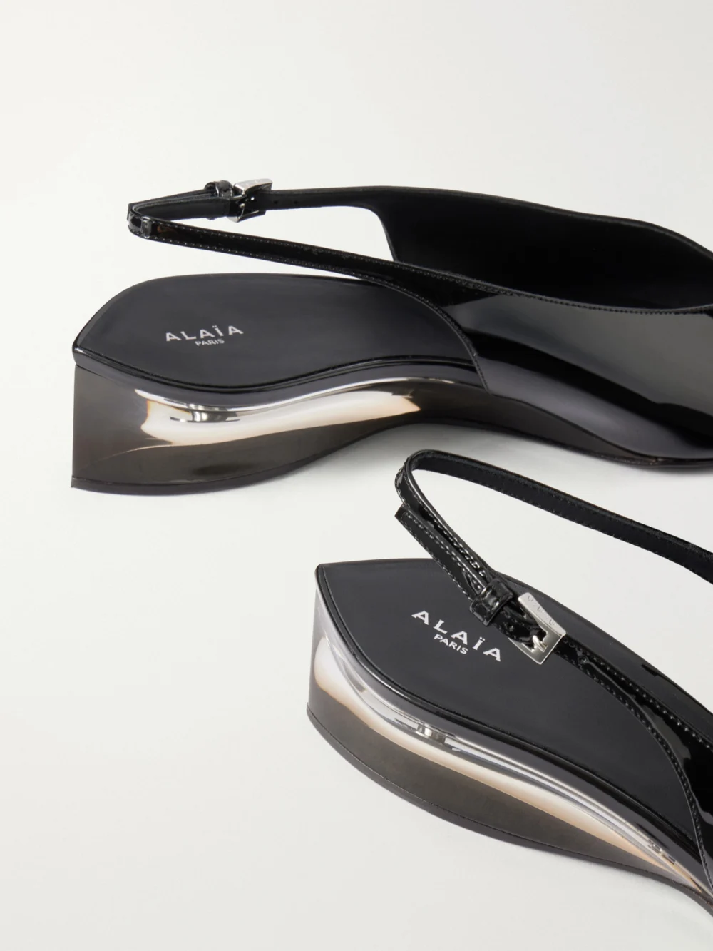 Close-up detail of the Alaïa 30 Patent-leather Wedge Slingback Pumps
