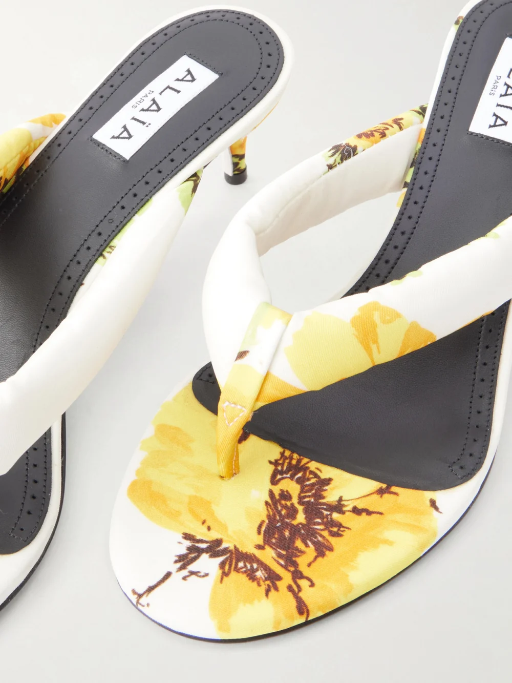 Close-up detail of the Alaïa 55 Floral-print Twill Thong Mules