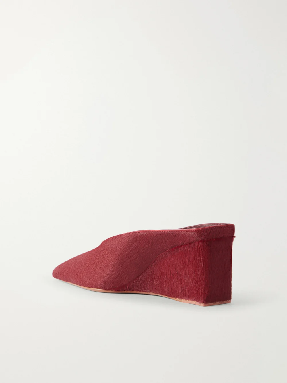 Back view of the Alaïa 75 Calf Hair Wedge Mules