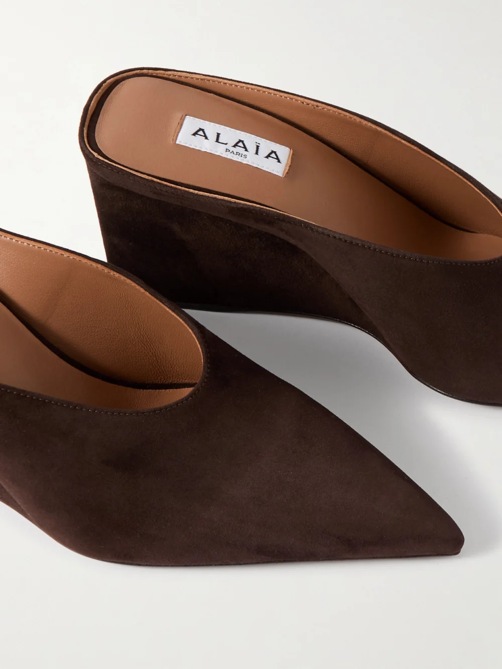 Close-up detail of the Alaïa 75 Suede Point-toe Wedge Mules