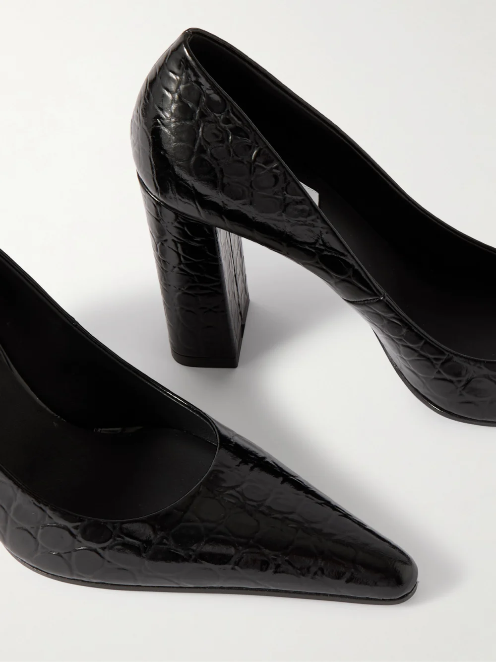Close-up detail of the Alaïa 90 Croc-effect Leather Pumps
