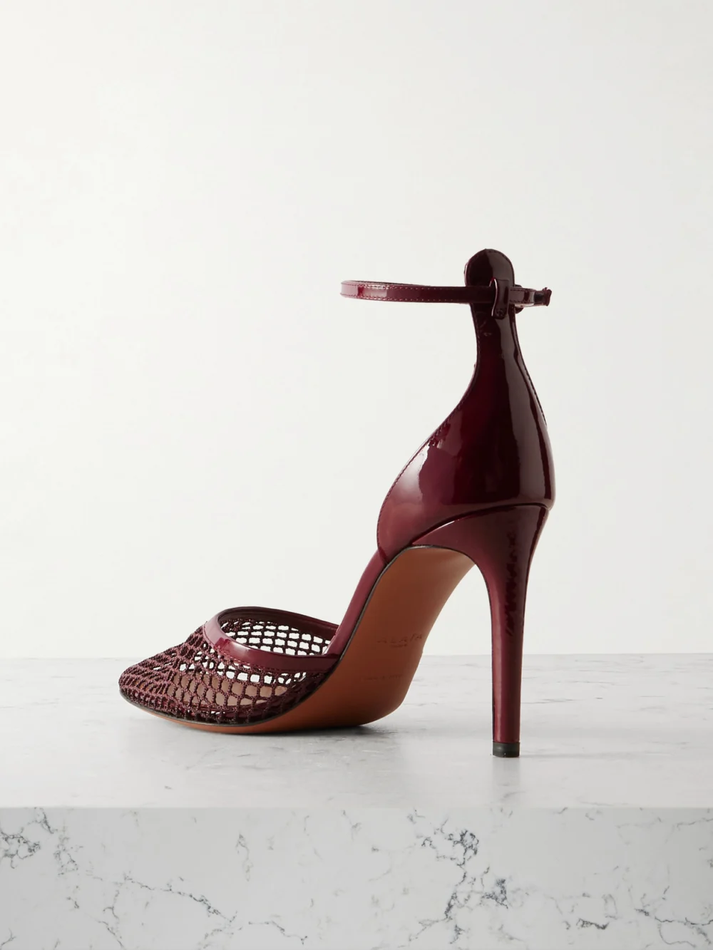 Back view of the Alaïa 90 Fishnet and Patent-leather Pumps
