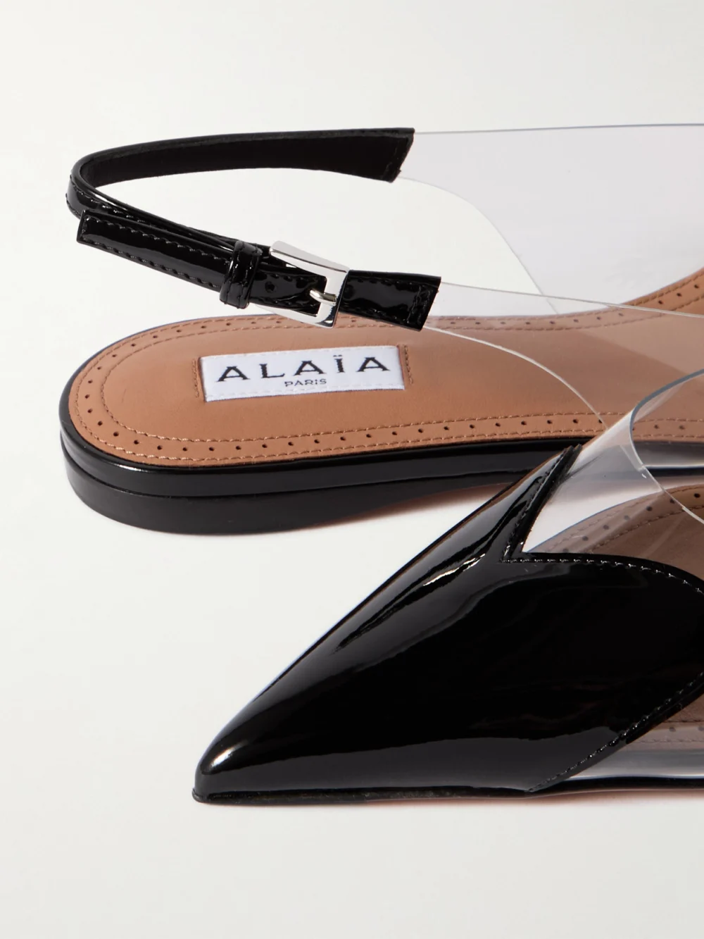 Close-up detail of the Alaïa Caur Pu and Patent-leather Slingback Point-toe Flats
