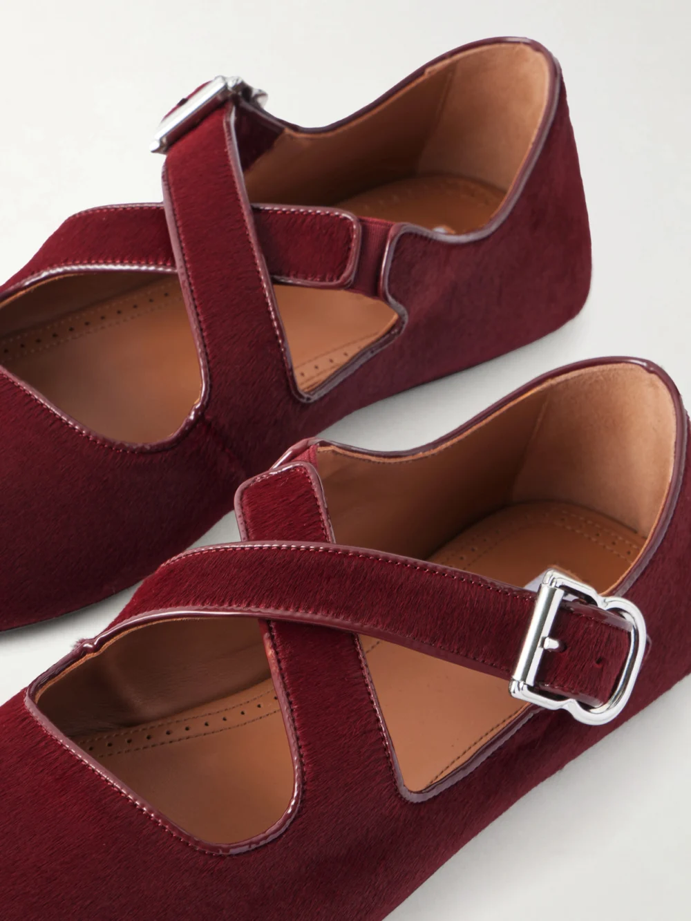 Close-up detail of the Alaïa Criss Cross Leather-trimmed Calf Hair Ballet Flats