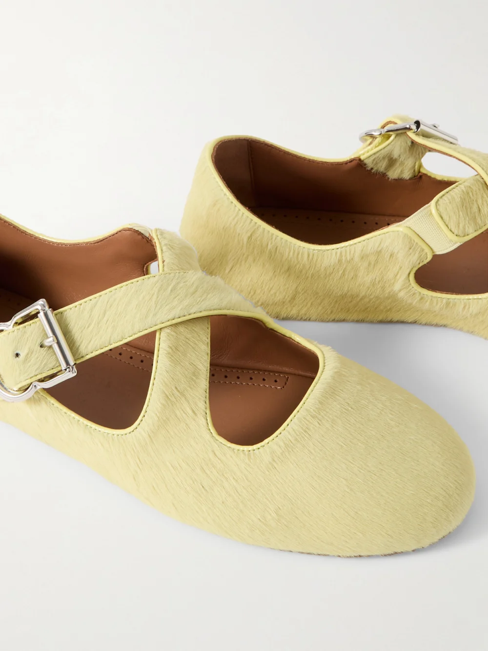 Close-up detail of the Alaïa Criss Cross Leather-trimmed Calf Hair Ballet Flats