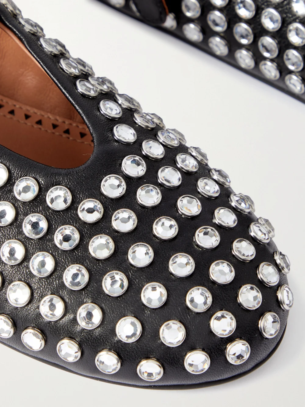 Close-up detail of the Alaïa Crystal-embellished Leather Ballet Flats