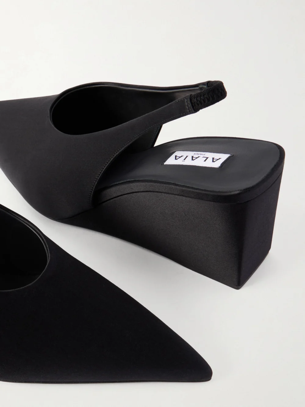 Close-up detail of the Alaïa Cube 75 Satin Slingback Wedge Pumps