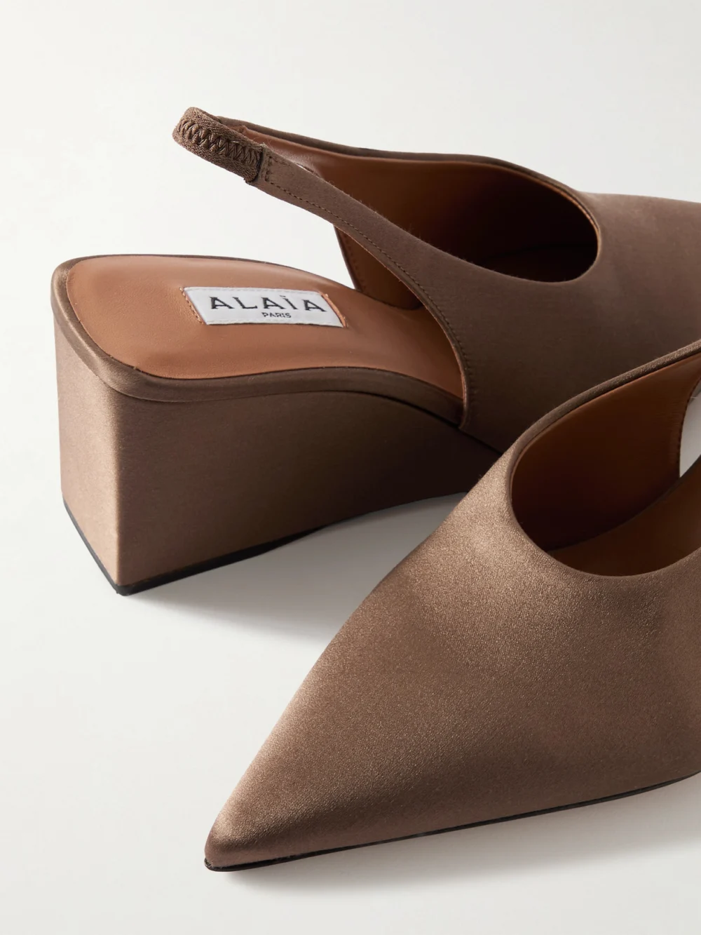 Close-up detail of the Alaïa Cube 75 Satin Slingback Wedge Pumps