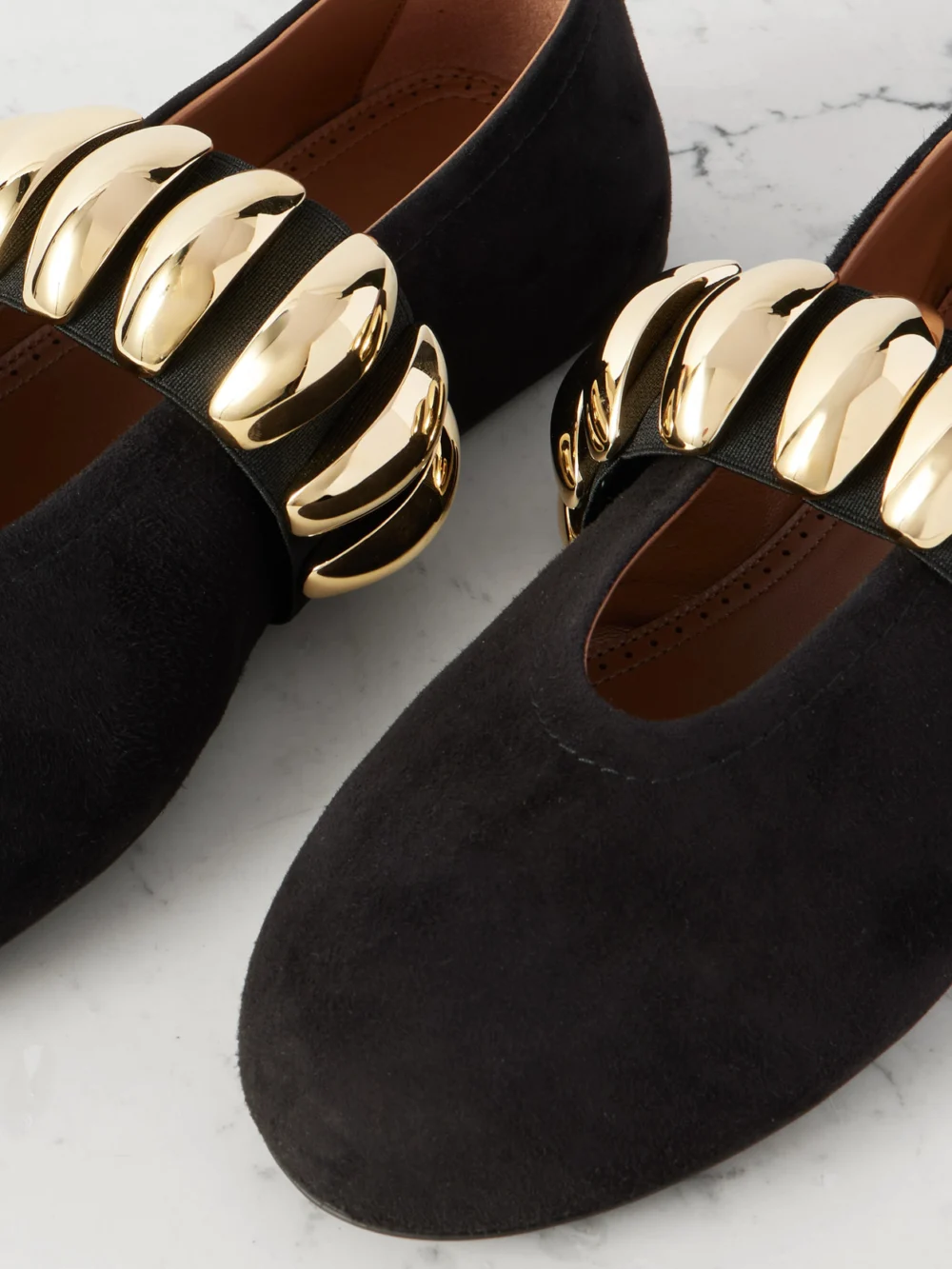 Close-up detail of the Alaïa Embellished Suede Ballet Flats