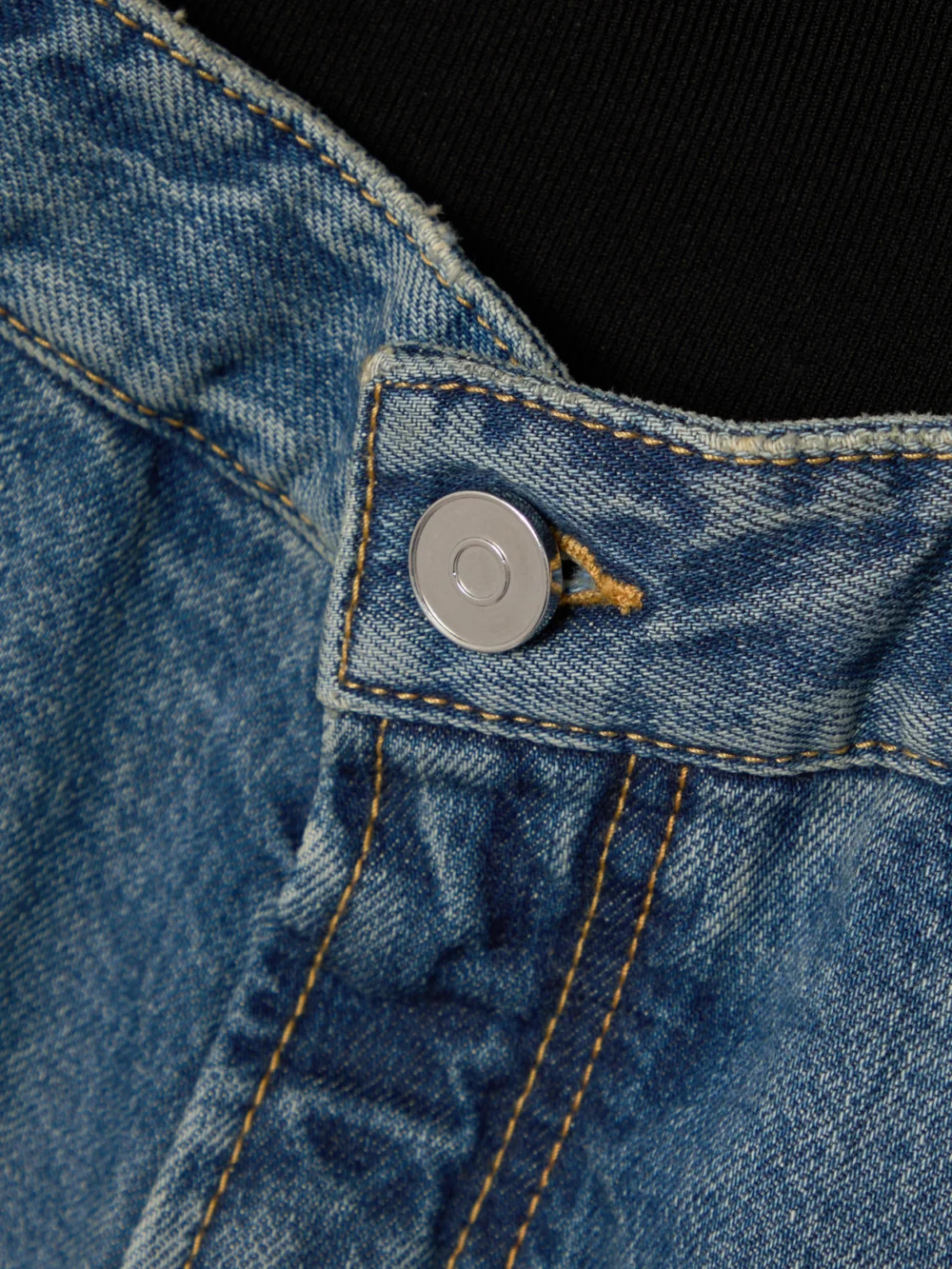 Close-up detail of the Alaïa Jersey-trimmed Denim Shorts