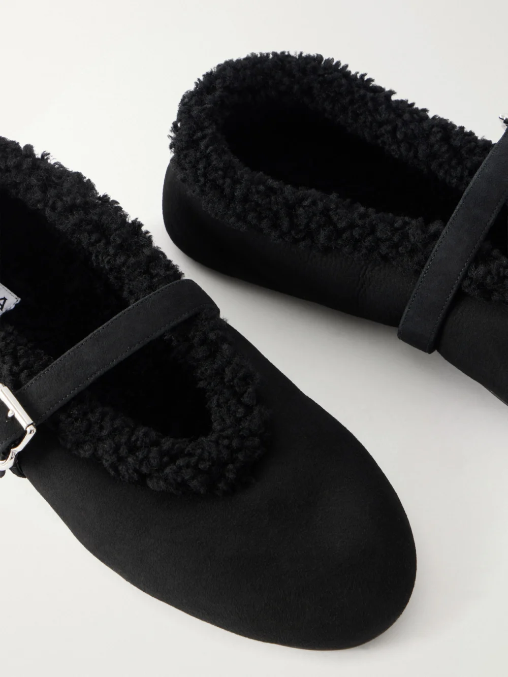 Close-up detail of the Alaïa La Ballerine Shearling-trimmed Suede Ballet Flats