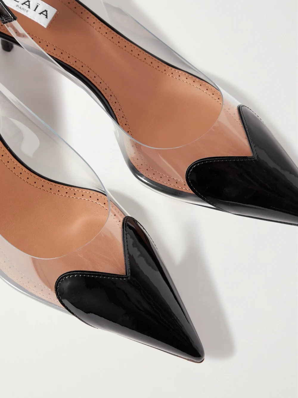 Close-up detail of the Alaïa Le Caur 55 Pu and Patent-leather Slingback Pumps