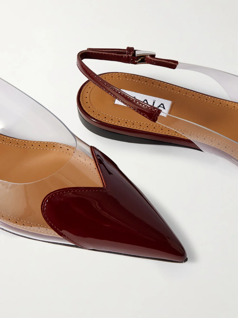 Close-up detail of the Alaïa Le Caur Pu and Patent-leather Slingback Point-toe Flats