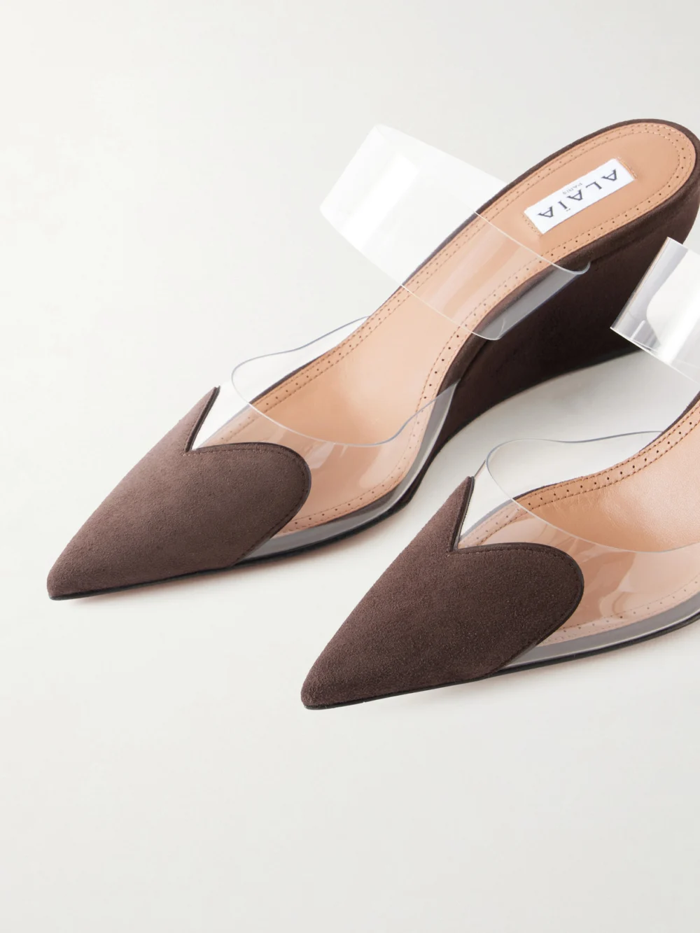 Close-up detail of the Alaïa Le Coeur 60 Suede and Pvc Wedge Mules