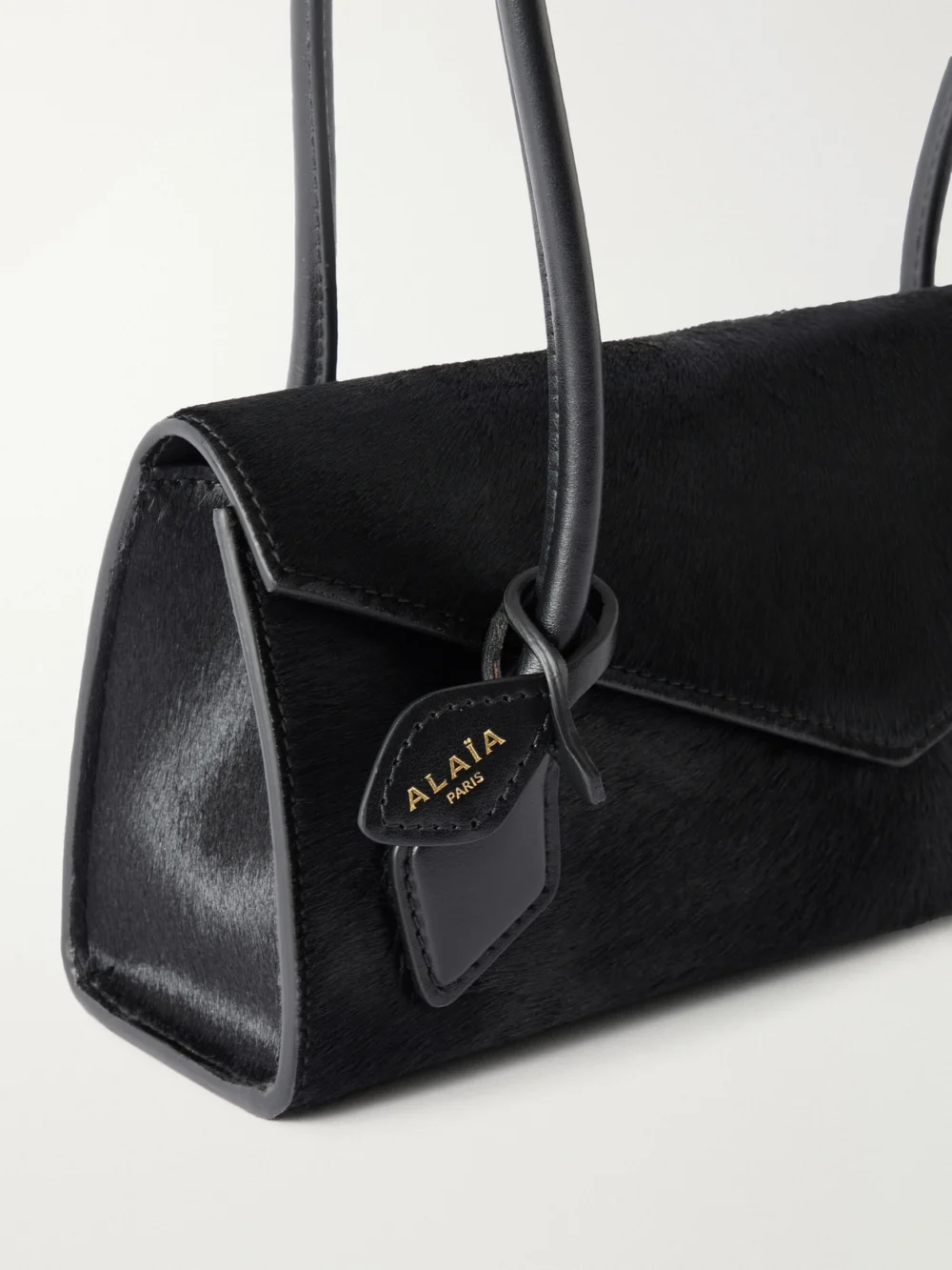 Close-up detail of the Alaïa Le Teckel Flap Small Leather-trimmed Calf Hair Shoulder Bag