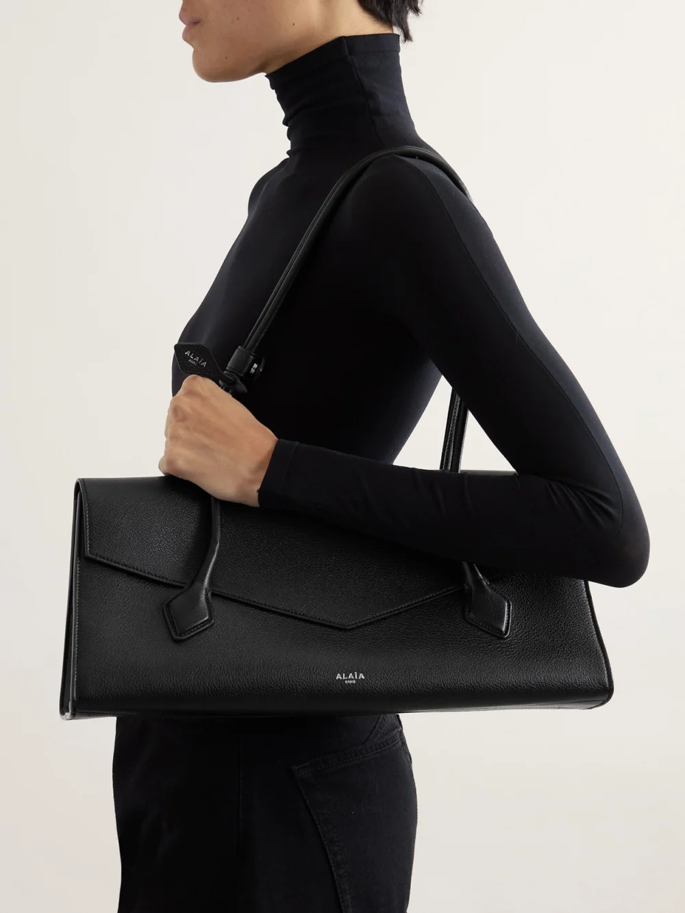 Alaïa Le Teckel Flap Textured-leather Shoulder Bag, styled view