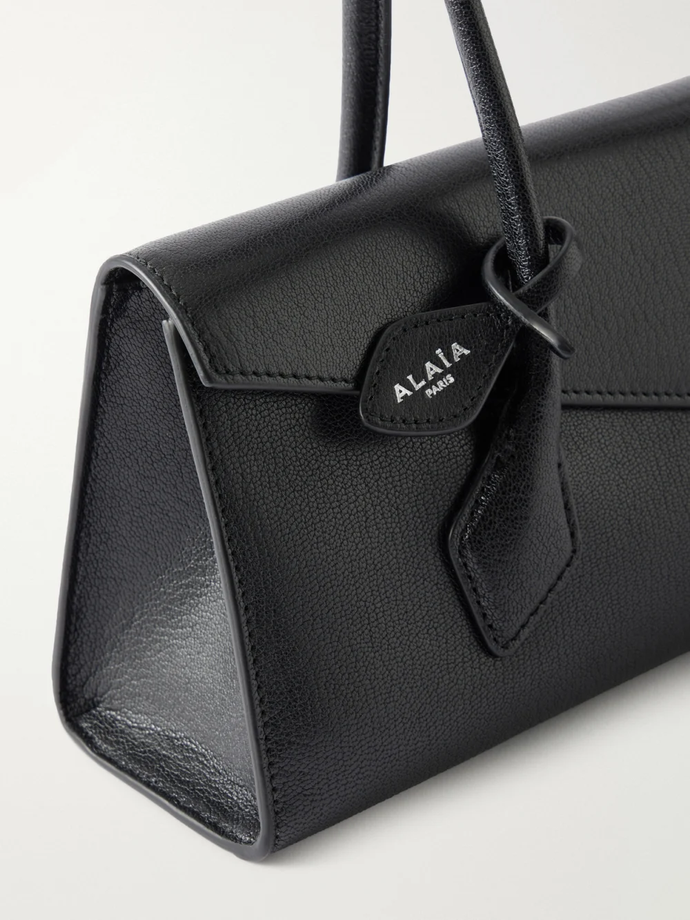Close-up detail of the Alaïa Le Teckel Flat Medium Leather Shoulder Bag