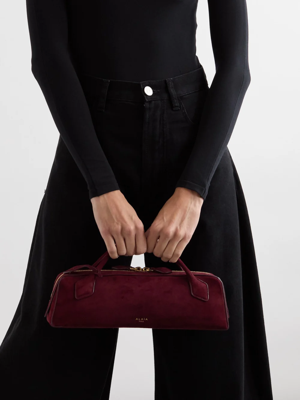 Alaïa Le Teckel Leather-trimmed Suede Clutch, styled view