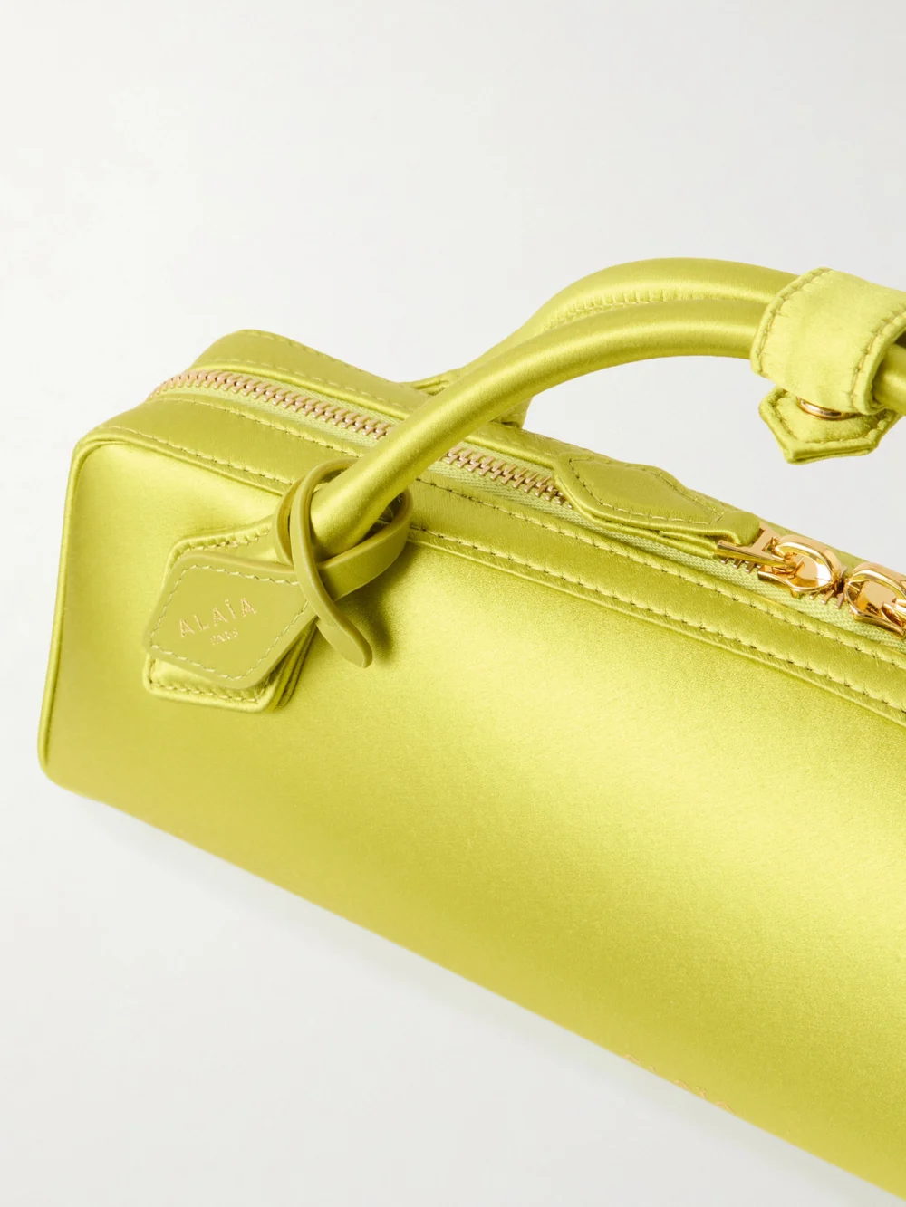Close-up detail of the Alaïa Le Teckel Satin Top-handle Bag