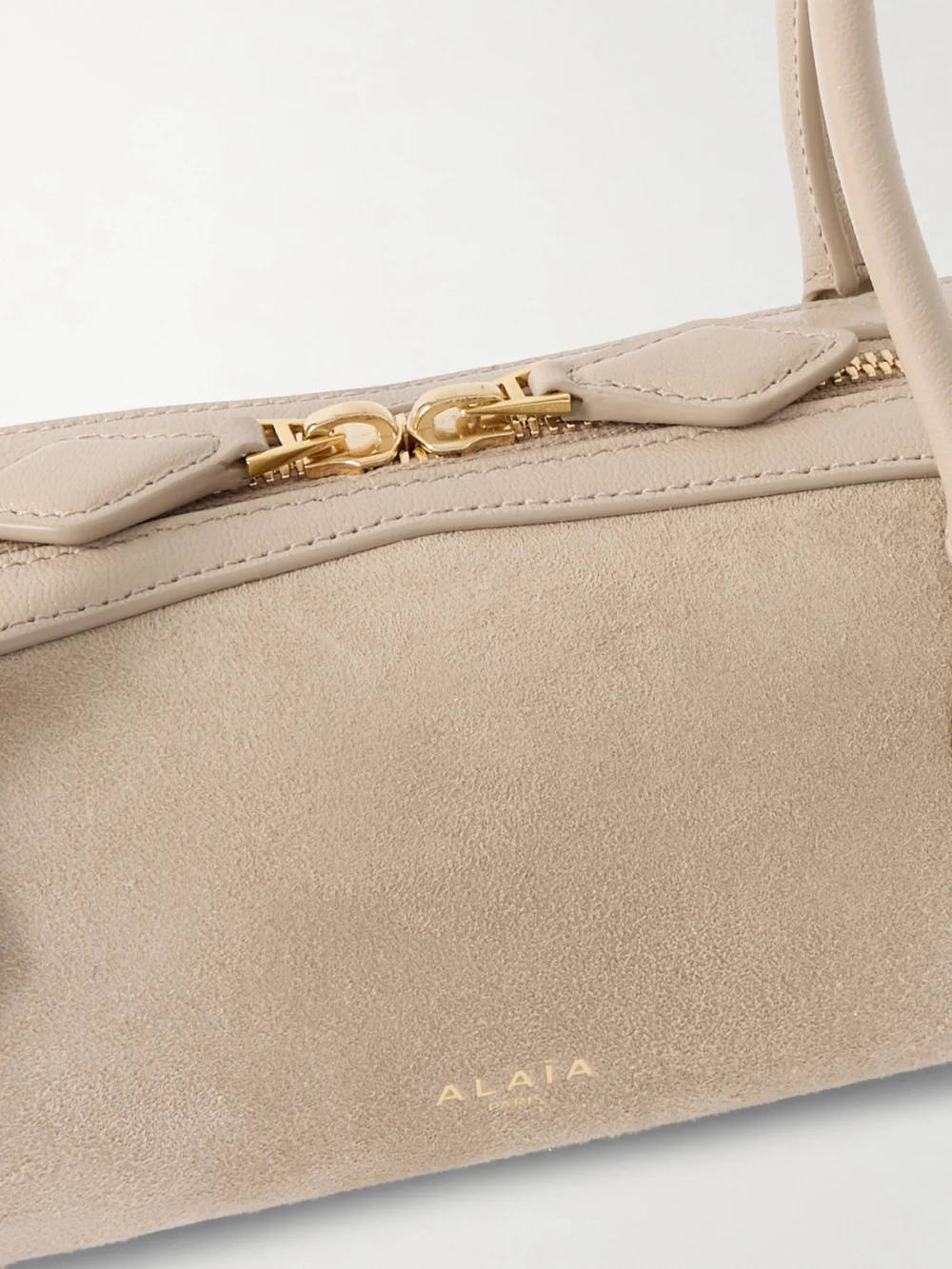 Close-up detail of the Alaïa Le Teckel Small Leather-trimmed Suede Shoulder Bag