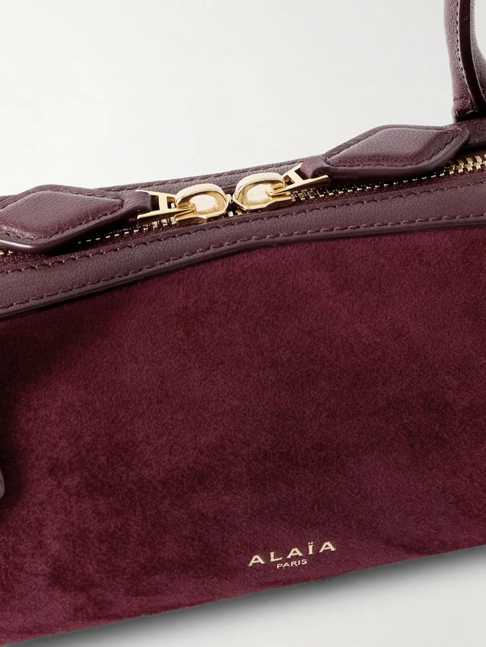 Close-up detail of the Alaïa Le Teckel Small Leather-trimmed Suede Shoulder Bag
