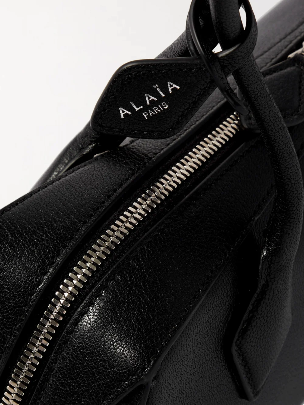 Close-up detail of the Alaïa Le Teckel Textured-leather Shoulder Bag