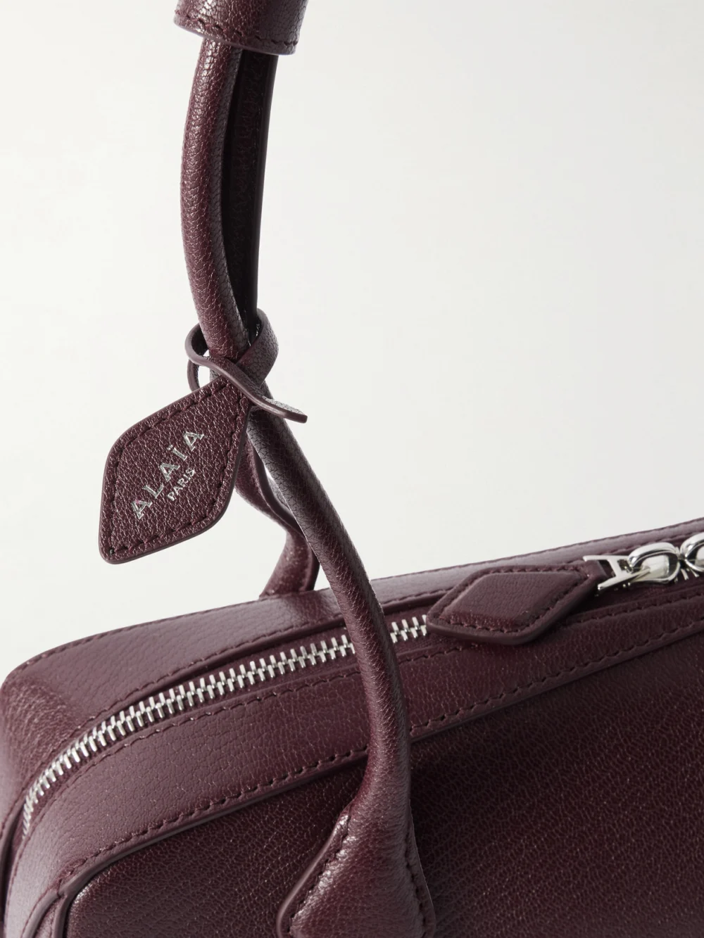 Close-up detail of the Alaïa Le Teckel Textured-leather Shoulder Bag