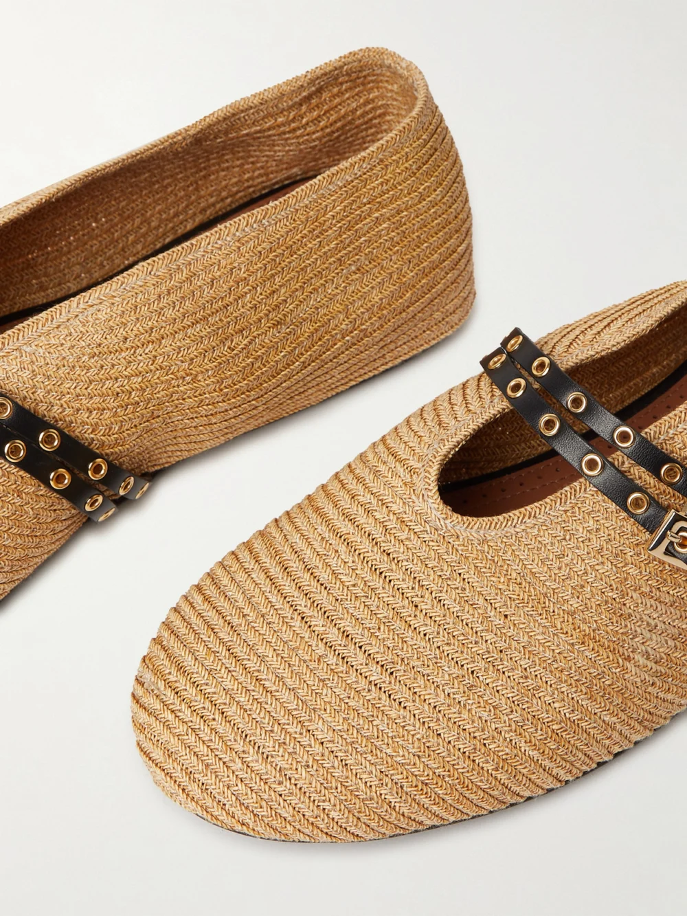 Close-up detail of the Alaïa Leather-trimmed Raffia Ballet Flats