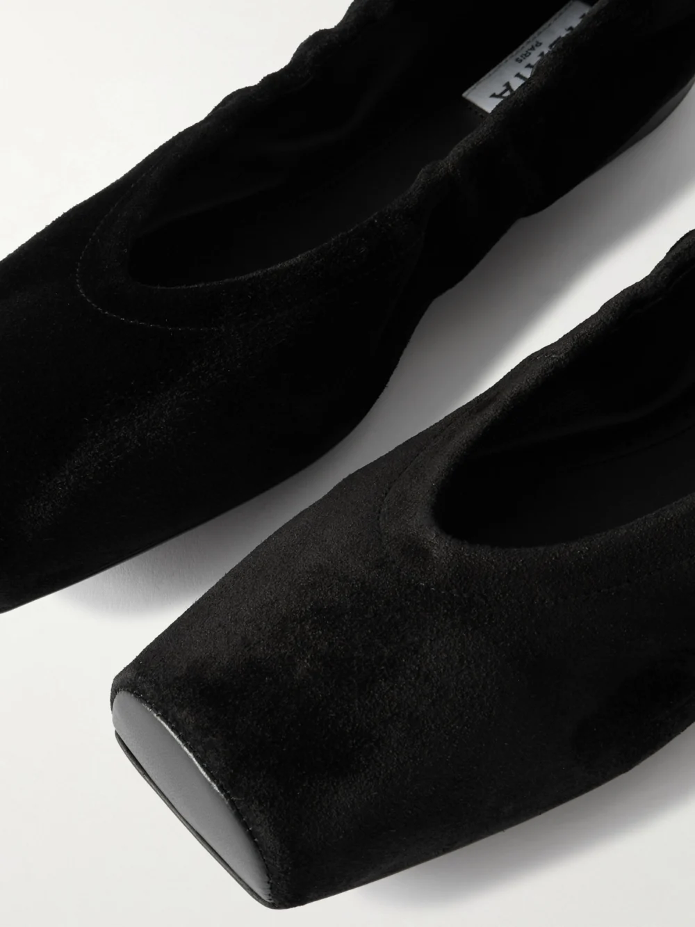 Close-up detail of the Alaïa Leather-trimmed Suede Ballet Flats