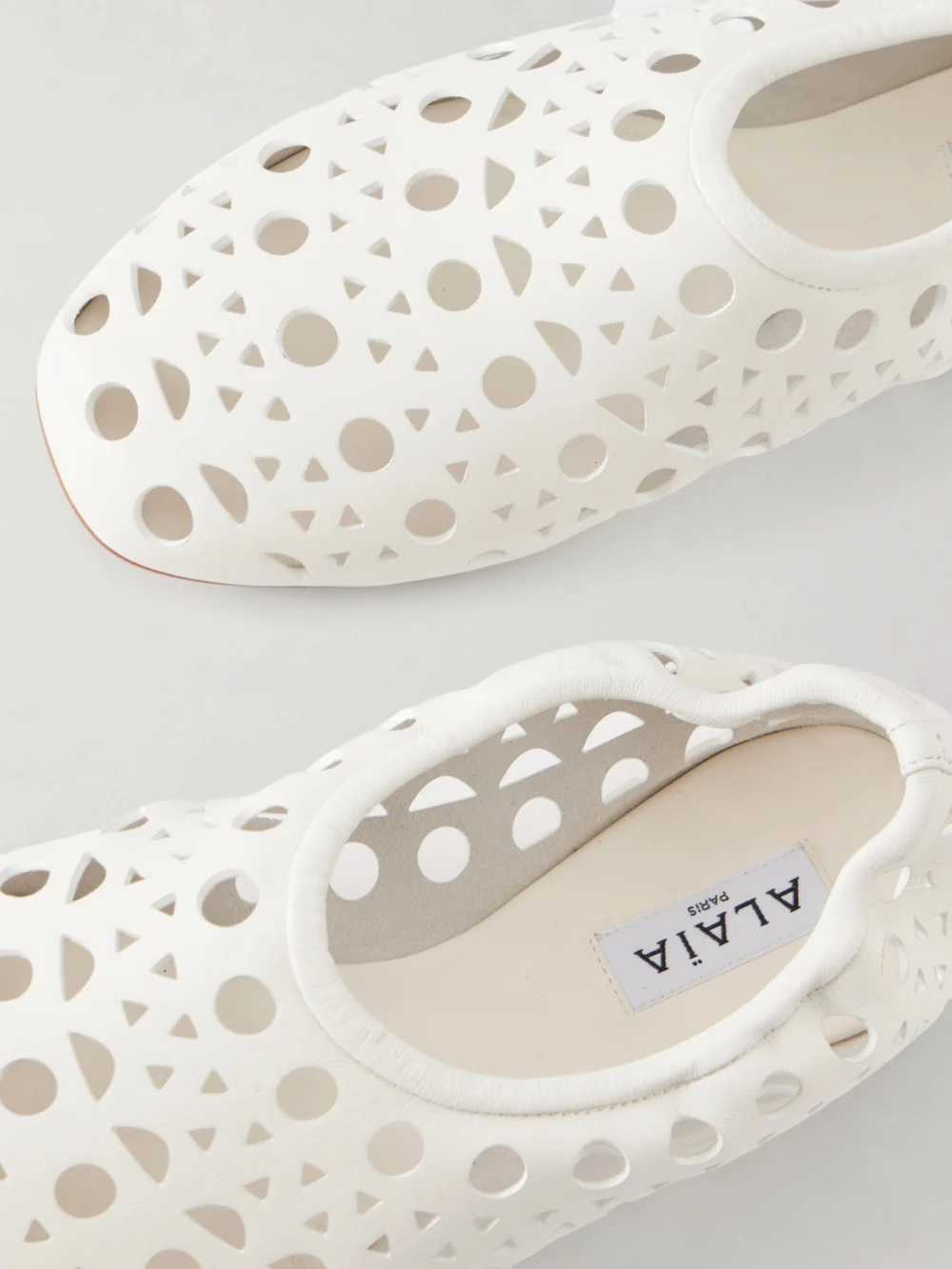 Close-up detail of the Alaïa Neo Vienne Laser-cut Leather Ballet Flats