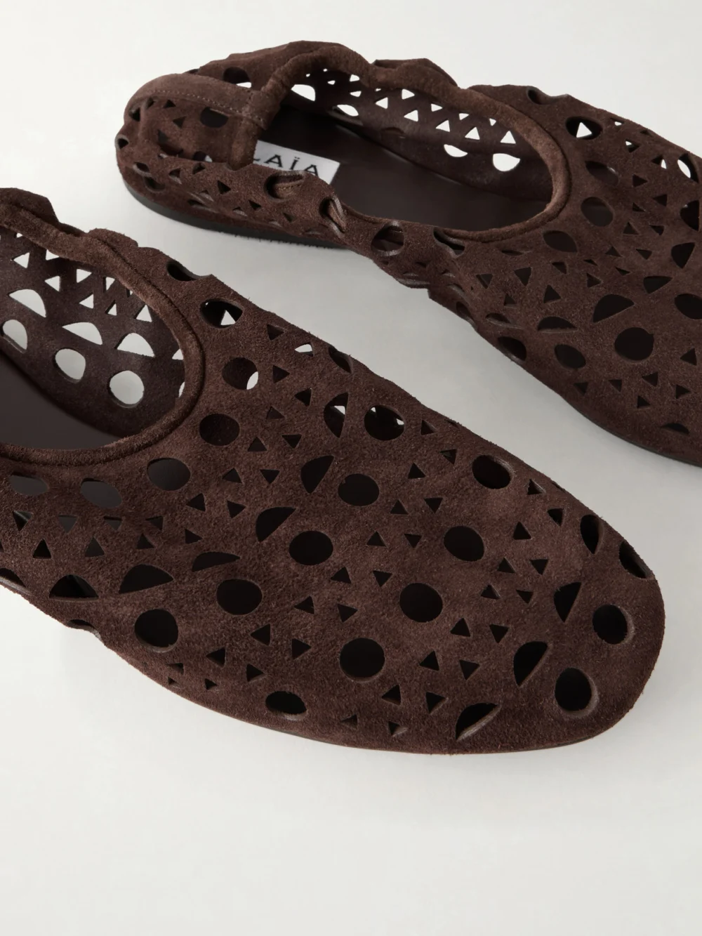 Close-up detail of the Alaïa Neo Vienne Perforated Suede Ballet Flats
