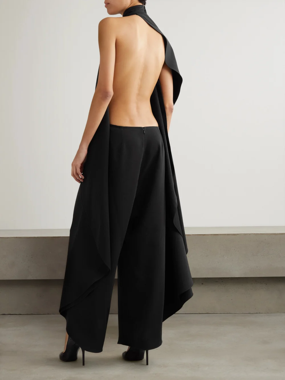 Back view of the Alaïa Open-back Asymmetric Grain De Poudre Wool-blend Jumpsuit