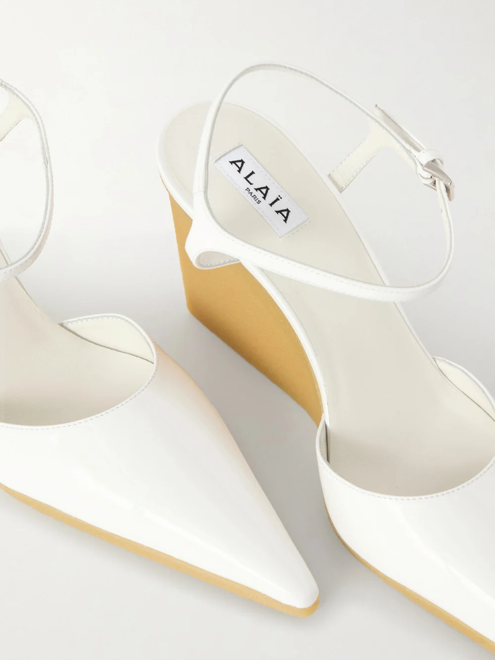 Close-up detail of the Alaïa Patent-leather Wedge Pumps