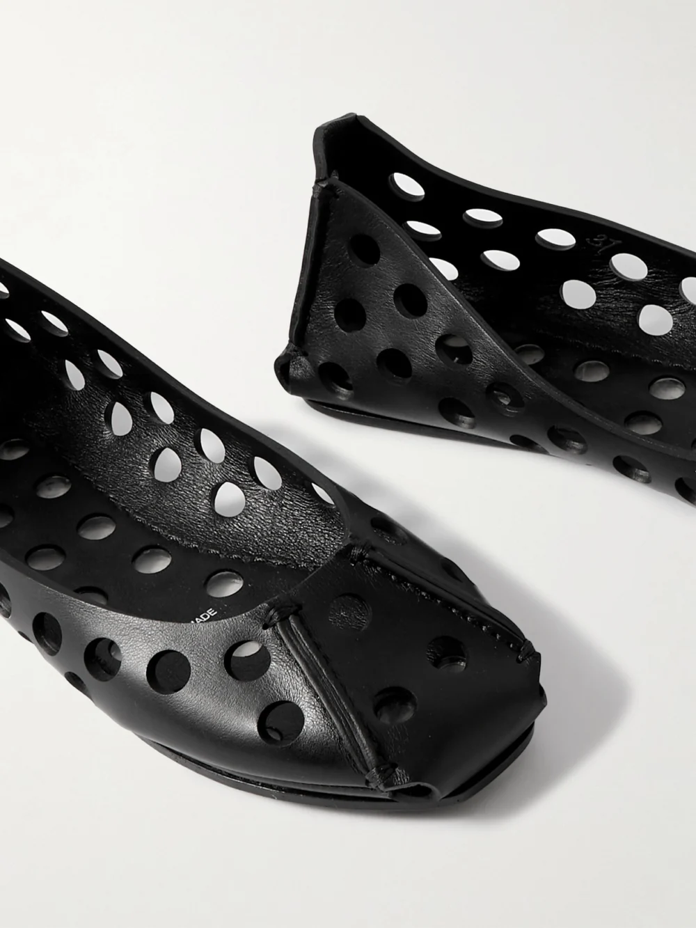 Close-up detail of the Alaïa Perforated Leather Ballet Flats